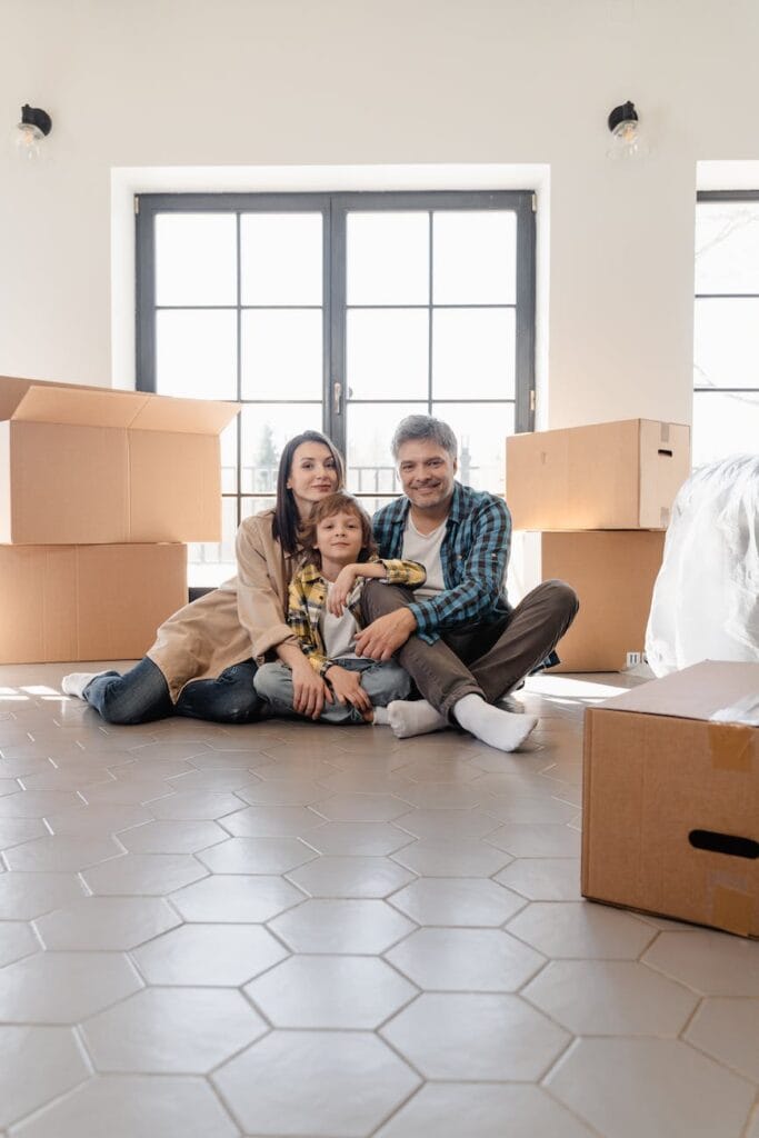 people sitting on the floor with big boxes surrounding them