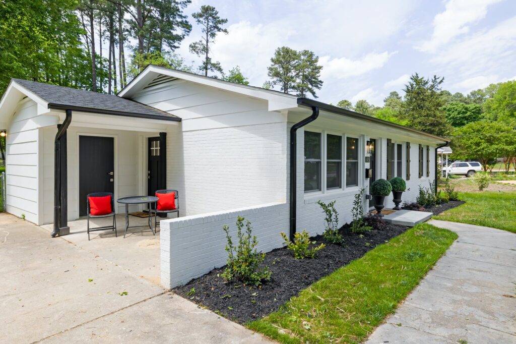 white and gray house near green trees