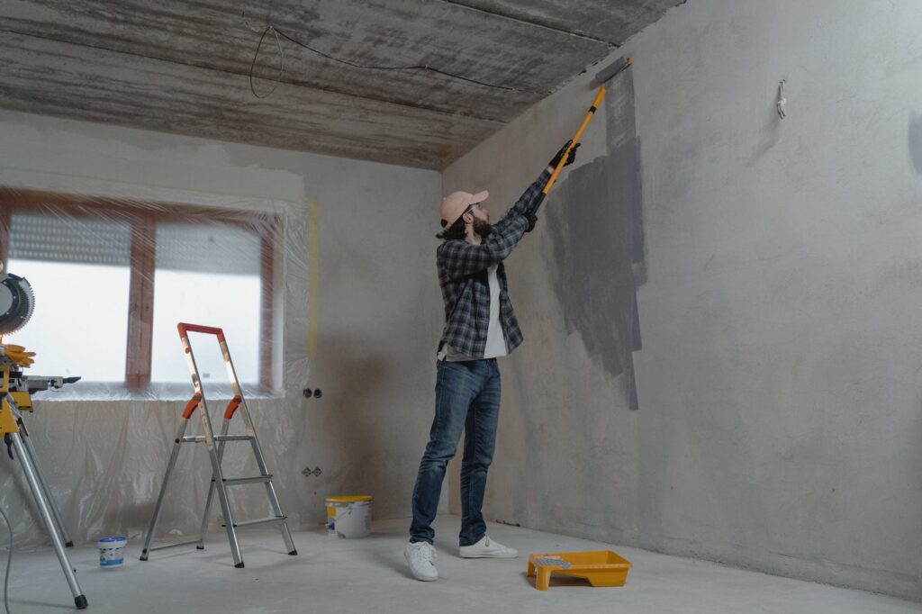 man painting the wall for home renovations