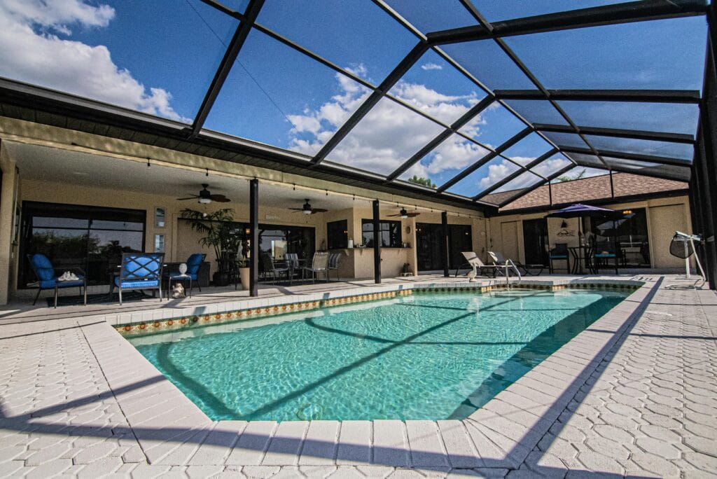 Spacious indoor pool area under a sunlit glass roof, perfect for relaxation and leisure.